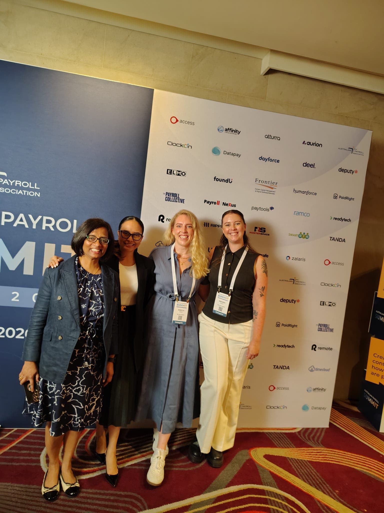 Four attendees posing together at the Australian Payroll Summit in Sydney